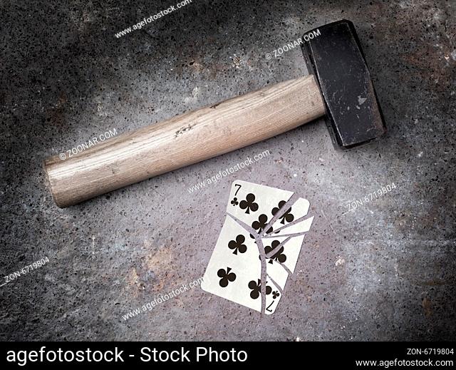 Hammer with a broken card, vintage look, seven of clubs