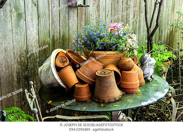 Table with terra-cotta pots in a garden setting.Georgia USA