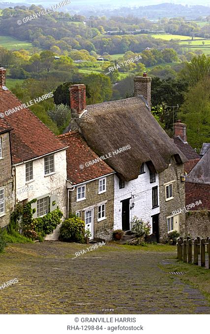 Classic English cottages besides the cobbled street of Gold Hill, Shaftesbury, Dorset, England, United Kingdom, Europe