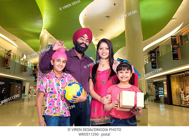 Sikh parents with children in mall MR702Z, 702Y, 702X, 779A