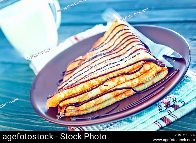 sweet pancakes with chocolate on the white plate