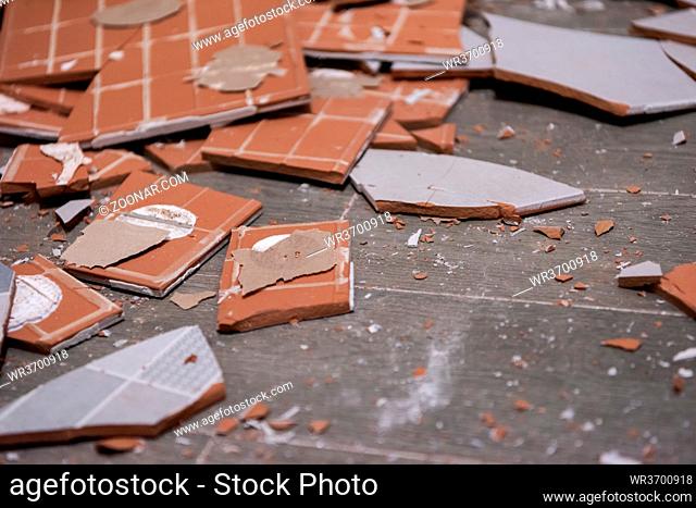 Pile of broken ceramic tiles remains after bathroom renovation prepared to be thrown into the trash Can be use as textured background