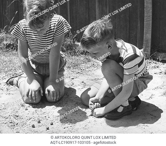 Photograph - Boys Playing Marbles, Dorothy Howard Tour, Australia, 1954, Black and white photograph depicting two boys playing marbles on sandy ground