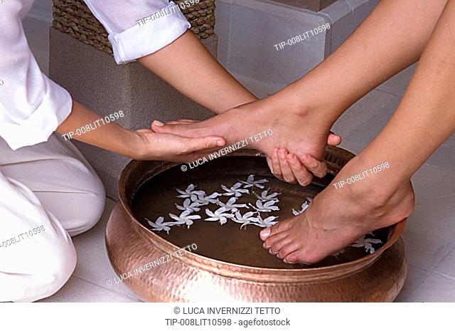 Woman having her feet washed