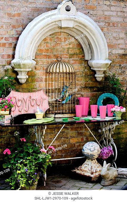 PATIO AREA: architectural salvage reused for decoration in a secluded patio, bonjour sign, birdcage pink, lime green and aqua