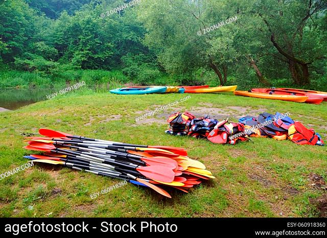 the oars from the canoes on the shore, preparing for the Canoeing