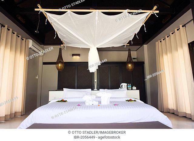 Bed with mosquito net in a luxury bungalow, The Sevenseas Resort, Ko Kradan, Koh Kradan, Trang, Thailand, Southeast Asia, Asia