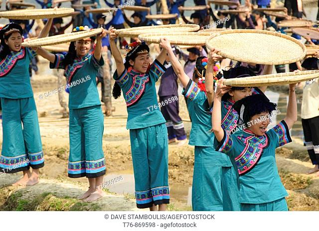 Hani Akha women and their rice sifting baskets at a festival in Yuanyang China