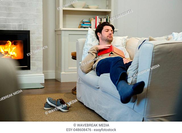 Man sleeping on sofa in living room
