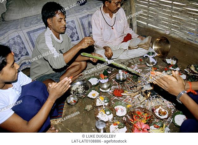 People performing Puja, where prayers and respect is given to the choosen god or goddess, at Khudunabari Bhutanese refugee camp