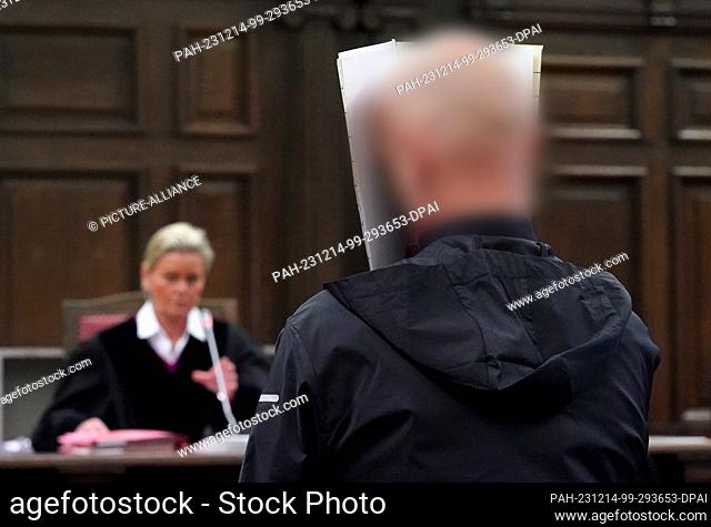 14 December 2023, Hamburg: The defendant stands in the courtroom in the criminal justice building at the start of the trial for attempted murder