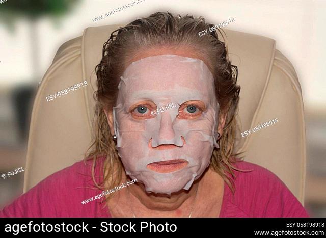 Spa therapy for woman getting facial mask in beauty salon