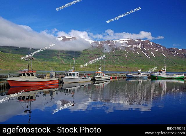 Small fishing boats and high, snow-capped mountains, fjord, Seydisfjördur, Iceland, Europe