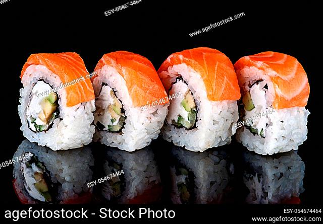 Sushi roll Philadelphia in row rotated. Black background with reflection
