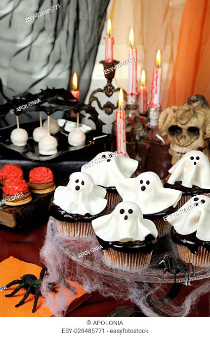 Smorgasbord ?upcakes in chocolate glaze decorated marzipan ghosts on Halloween