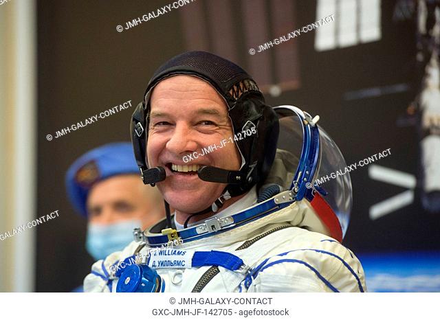 In the Integration Facility at the Baikonur Cosmodrome in Kazakhstan, Expedition 47-48 crewmember Jeff Williams of NASA flashes a smile as he suits up in his...