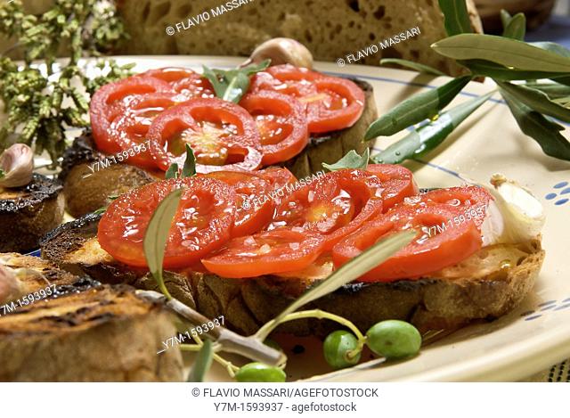 dish of 'bruschetta' bread with tomato, arugula, oil