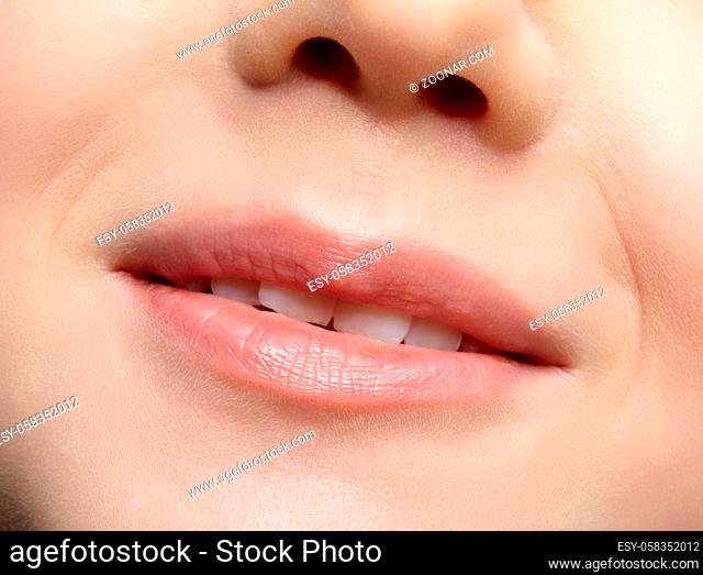 Human mouth and nose. Closeup macro portrait of young female teenager part of face
