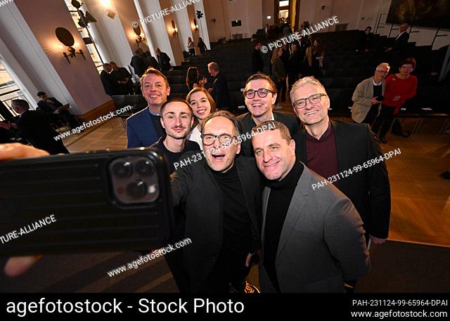 24 November 2023, Bavaria, Munich: The winners of the Press Photo of the Year 2023, Florian Bachmeier (l-r), Lorenz Mehrlich, Jana Vogel, Alexander Hassenstein