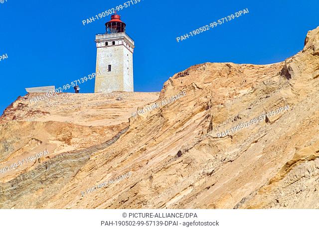 22 April 2019, Denmark, Lönstrup: The lighthouse Rubjerg Knude on the steep North Sea coast in the municipality Rubjerg (municipality Hjörring) near the...