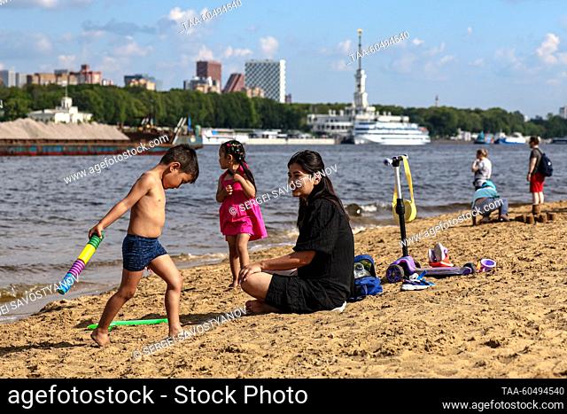 RUSSIA, MOSCOW - JULY 16, 2023: People are seen by the Moscow Canal in Severnoye Tushino Park. Sergei Savostyanov/TASS