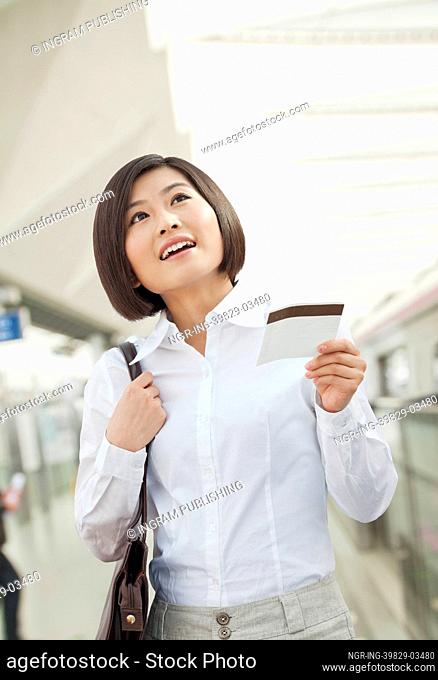 Young Woman Holding a Train Ticket