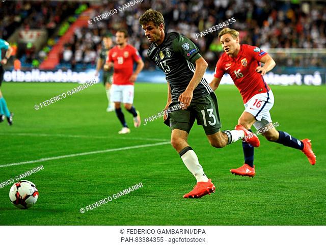 Thomas Mueller (L) of Germany and Jonas Svensson of Norway in action during the FIFA World Cup Qualifiers Europe Group C soccer match between Norway and Germany...