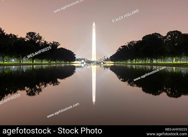 USA, Washington DC, Washington Monument reflecting in Lincoln Memorial Reflecting Pool at night