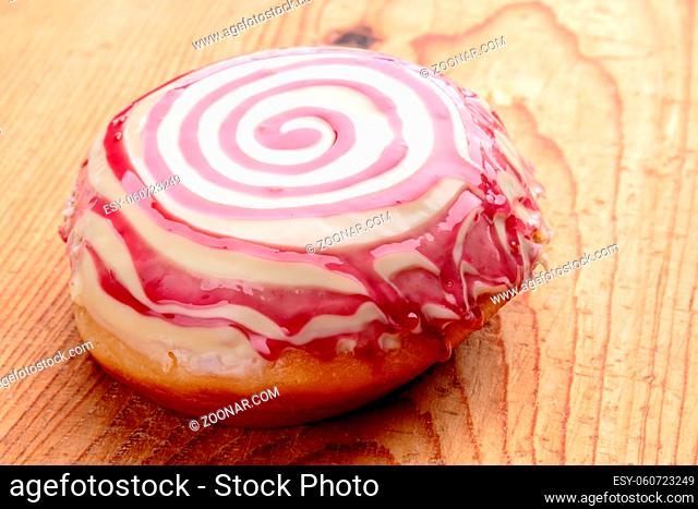 donut with spiral frosting on wooden table