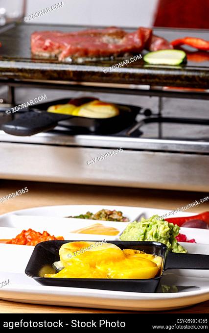 melting cheese in a raclette