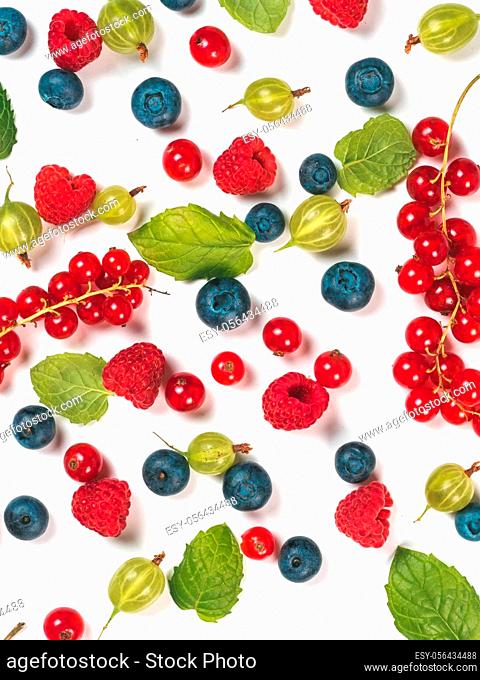 Various fresh summer berries background. Pattern of fresh blueberries, red currant, raspberries, gooseberries isolated on white background