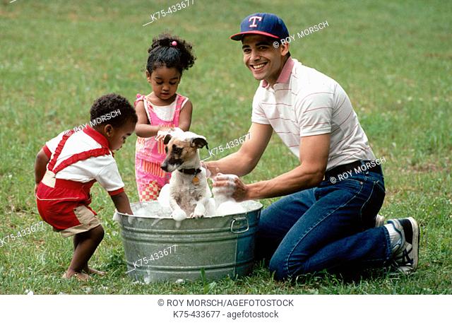 Dad and his children washing dog
