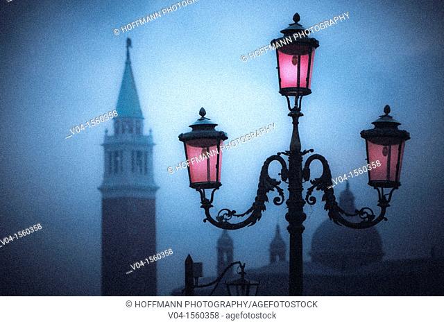 Mystical view of a glowing lantern and the Campanile in Venice, Italy, Europe