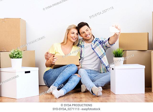 couple taking selfie and moving to new home