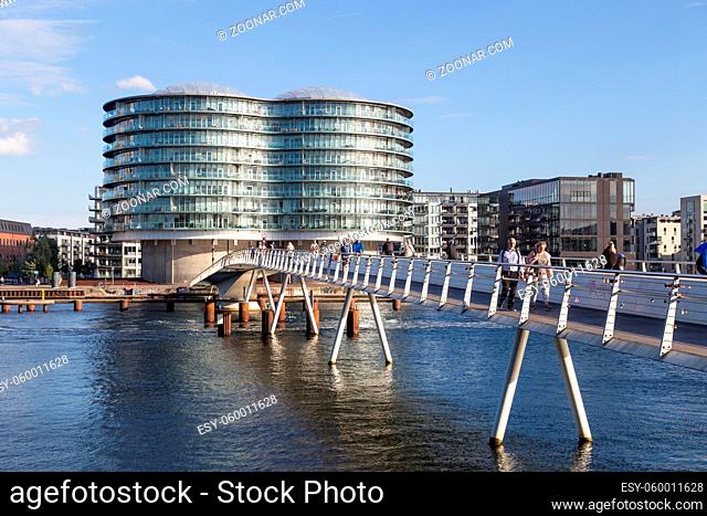 Copenhagen, Denmark - September 23, 2016: Modern cyclist bridge Bryggybroen and the Gemini Residence