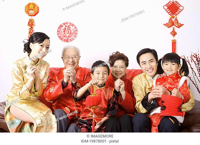 Family members in traditional clothes celebrating Chinese New Year