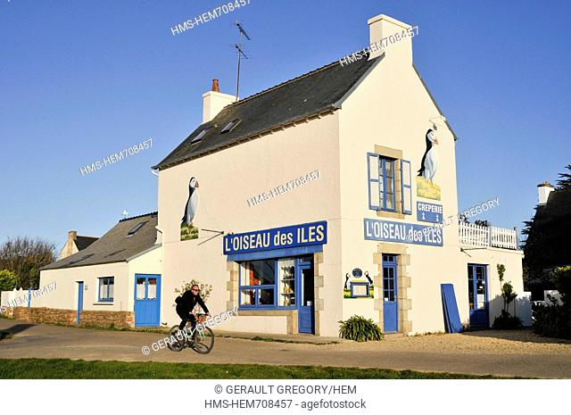 France, Cotes d'Armor, Brehat island, man cycling past the pancake house the bird islands