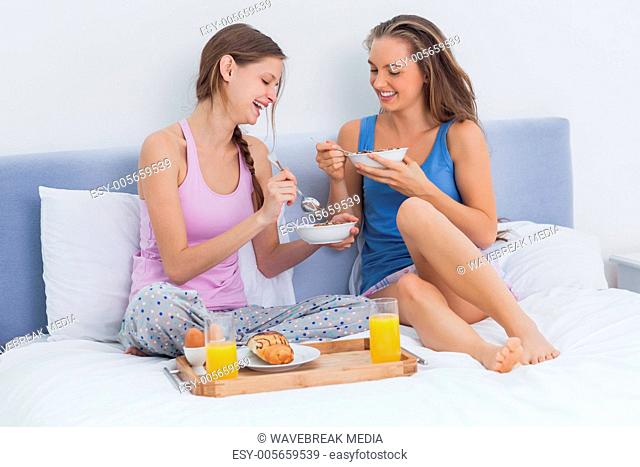Girls having breakfast in bed