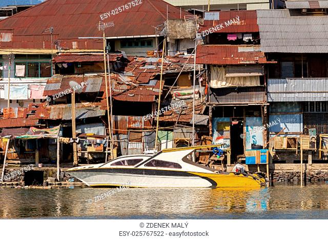 poor houses with sheet tin by the river, Kota Manado, North Sulawesi, Indonesia