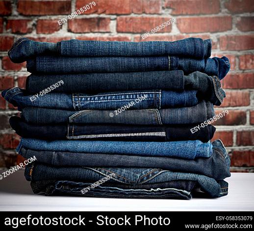 pile of folded blue jeans different, close up