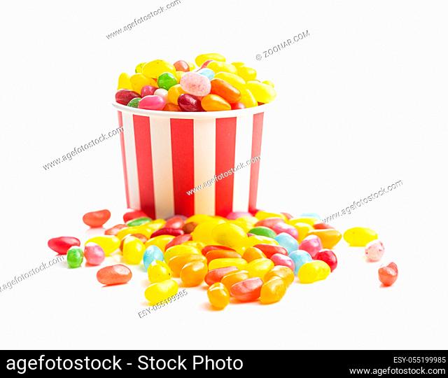 Fruity jellybeans. Tasty colorful jelly beans in paper cup isolated on white background