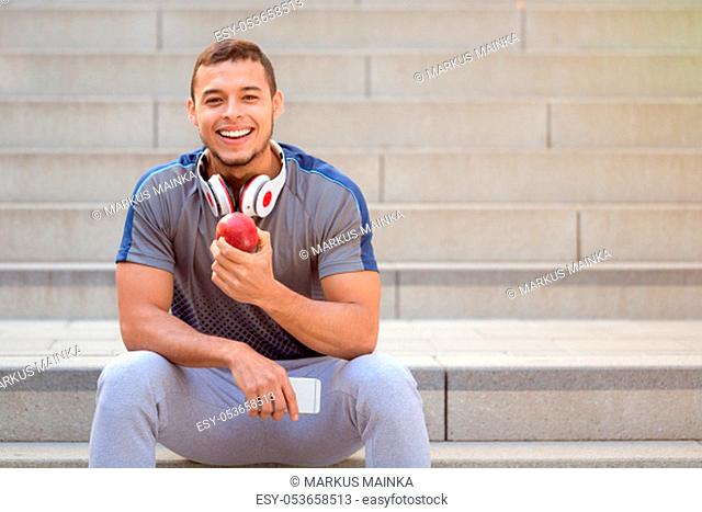 Healthy eating apple fruit runner smiling young man copyspace copy space sports training fitness outdoor