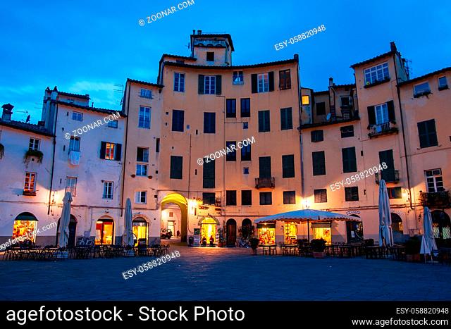 Lucca, Italy - March 3rd 2008: Beautiful historic architecture of Piazza dell'Anfiteatro in old town Lucca Italy on a cool winter's evening