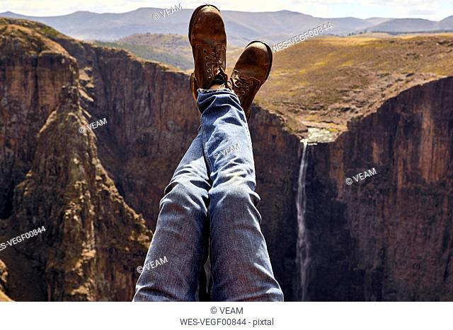Low section of a man with legs up in the mountains, Maletsunyane Falls, Lesotho