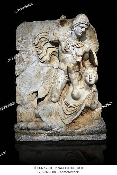 Roman Sebasteion relief sculpture of emperor Claudius and Britannia, Aphrodisias Museum, Aphrodisias, Turkey. Against a black background.