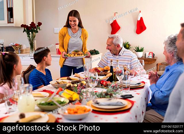 Multi generation caucasian family sitting at table for dinner together