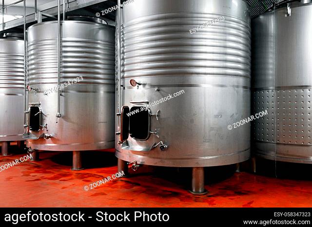 Steel barrels for fermentation of wine in winemaker factory. High quality photo