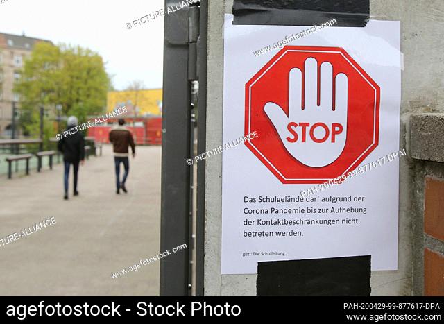 28 April 2020, Hamburg: At one school (Theodor Haubach School Primary School) there is a sign saying ""Stop - Due to the Corona Pandemic
