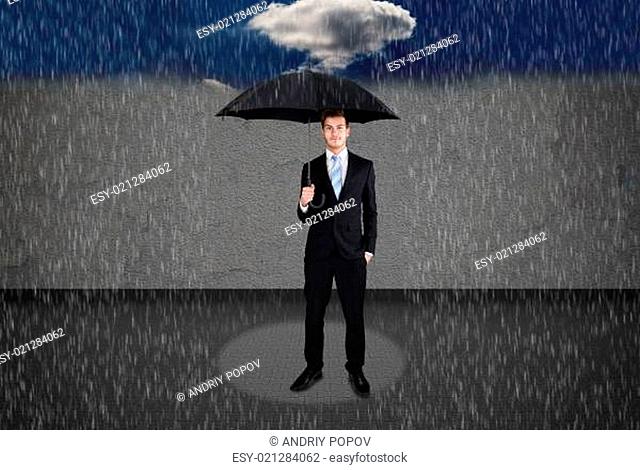 Businessman Holding Umbrella Under Rain
