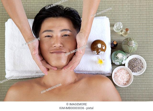 Man enjoying massaging and smiling at the camera